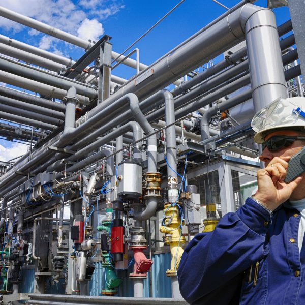 oil worker with giant pipelines construction